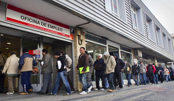 People queue outside an unemployment registry office in Madrid on Thu