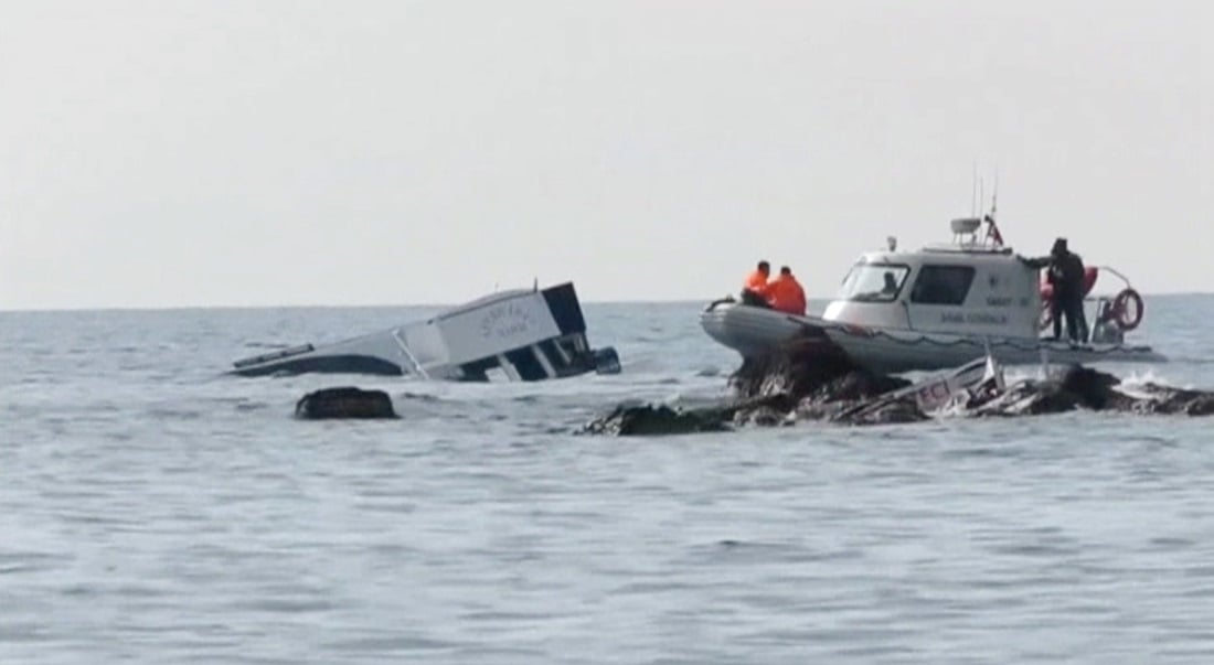 A boat (L) which carried migrants sinks into the sea off Turkey's western coast of Ayvacik, are seen in this still image from video taken January 30, 2016. Almost 40 people drowned and 75 were rescued after a boat carrying migrants to Greece sank off Turkey's western coast on Saturday, according to local officials and the Turkish Dogan news agency. The Turkish coast guard was continuing search and rescue efforts where the 17-metre boat carrying at least 120 people sank off the coast of Ayvacik, a town across from the Greek island of Lesvos, the Dogan news agency reported. REUTERS/Reuters TV