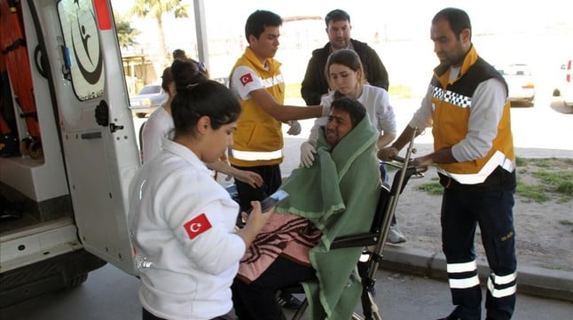 Medics take care of a rescued migrant at a local hospital in the Aegean resort of Didim Turkey Sunday March 6 2016 Turkey s state-run news agency says 18 migrants have drowned off the Turkish coast while trying to reach Greece Anadolu Agency says the coast guard rescued 15 other migrants off the Aegean Sea resort of Didim The coast guard has launched a search-and-rescue mission for other migrants believed to be missing from the accident Sunday AP Photo Huseyin Caliskan